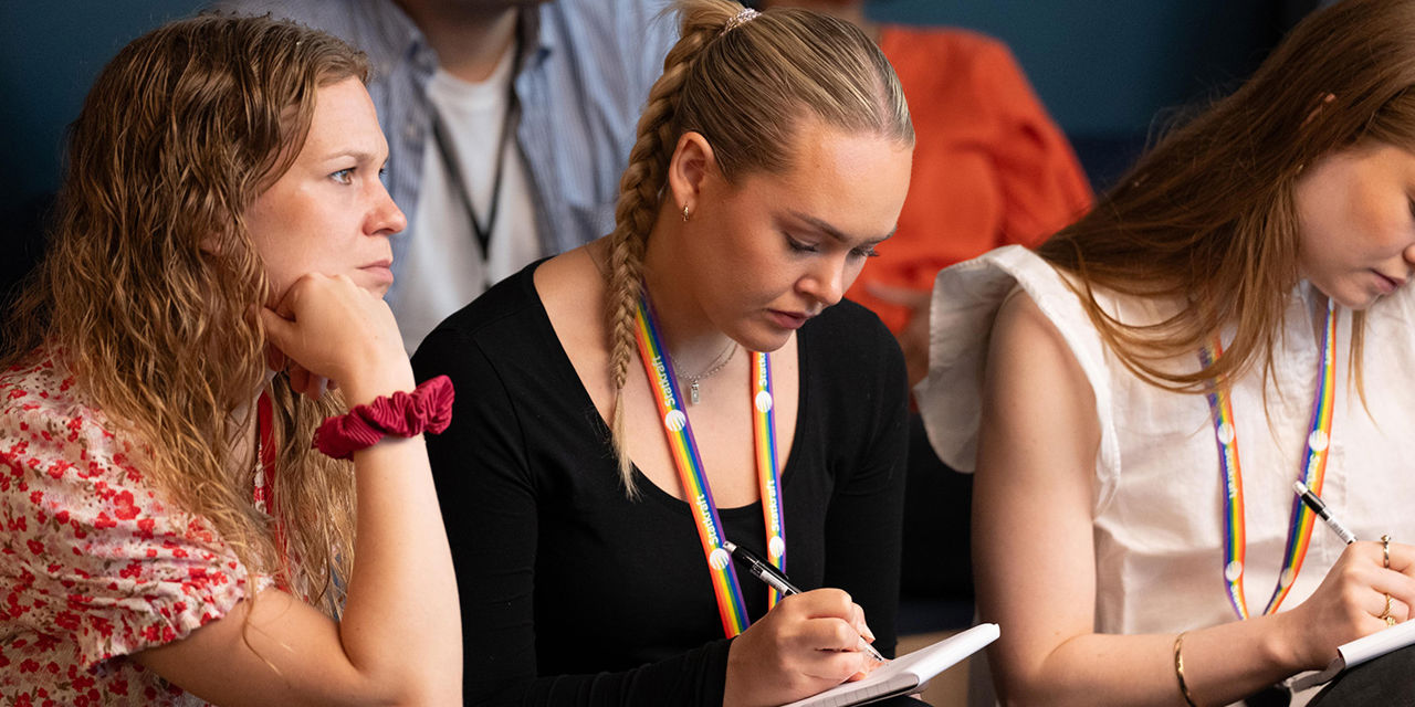 People taking notes in meeting